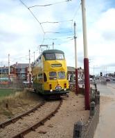 Blackpool Transport double deck <I>Balloon Car</I> No. 711 negotiates the sand filled turning circle at Starr Gate to head for Fleetwood. The bridge in the background carries the road over the Blackpool South railway line and marks the entrance to Squires Gate station. Shortly after this image was taken the tracks were lifted to allow a refurbishment in connection with the new tram depot construction. 711 was later rebuilt with wider entrances to be compatible with the new platforms. [See image 54343]<br><br>[Mark Bartlett 11/08/2009]