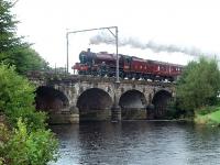 Heavy rain again for <I>Leander</I> on the <I>Fellsman</I> as it crosses the River Wyre at Scorton on the outbound leg. This bridge is known locally as Six Arches, five arches being over the river and the sixth over the access road to a caravan site of the same name. <br><br>[Mark Bartlett 02/09/2009]