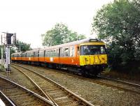 A Class 303 emu on a service from Newton to Glasgow Central via Maxwell Park in September 1997 is photographed skirting Cathcart station.<br><br>[David Panton /09/1997]