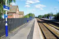 Looking west at Irlam, Greater Manchester, on 10 September 2009. The strange set back position of the old station building in relation to the platforms gives away the fact that the line was re-aligned in 1893 when the Manchester Ship Canal opened.<br><br>[Ewan Crawford 10/09/2009]