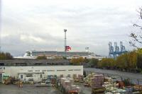 Looking over the site of Princes Pier on 19th October 2009 with the buildings in the foreground standing on the site of the former shed. In the background is the Queen Mary 2, calling at Greenock Ocean Terminal as part of her 5th Birthday celebrations. The visit continues a long tradition of ships calling at Greenock Ocean Terminal and, prior to that, Princes Pier, which occupied the site until 1966.  <br><br>[Graham Morgan 19/10/2009]
