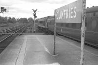 Looking north from Dumfries in 1965 with a Peak - hauled service (possibly the <I>Thames-Clyde Express</I>) pulling away from the platform. [See image 39421]<br>
<br><br>[Colin Miller //1965]