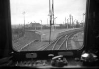 A view of the former triangular platform layout at Forres, taken from the rear of an Inverness-Aberdeen DMU on 2nd May 1968. The redundant platform to the left formerly served passenger workings from the Elgin direction to Aviemore via Dava and Grantown, the line beside it probably last being used for freight traffic prior to 1965 closure. The layout at Forres - with just a single platform - has remained virtually unchanged since then, despite regularly-voiced proposals to shift the crossing loop (the start of which can be seen in the centre-right of the photo) back into the station.<br>
<br><br>[David Spaven 02/05/1968]