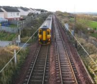A Waverley - Glasgow Central service heads west towards Kirknewton station on 27 November 2009. The DMU is passing the site of Camps Junction [see image 25874]. Nothing remains of the foot crossing or signal box that stood here, other than perhaps some charred wooden remains alongside the line on the right.   <br><br>[John Furnevel 27/11/2009]