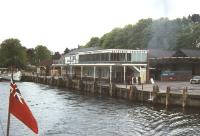 View of Lakeside pier and station in 1976 taken from a vessel on Lake Windermere. Note the overall roof and the nose of Fairburn 2-6-4T no 42085 standing at the buffer stops. The rear coaches of the train and the signal box can be seen in the left background.<br><br>[Colin Miller //1976]