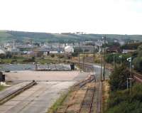 Scene from the gantry crane at the former Stockton Haulage yard, Stranraer, in 2004 looking south west. The Stockton Haulage yard area has since been cleared of all rail-related equipment and sidings, but the connection remains in situ. The yard is still owned, and protected for possible future freight use, by Network Rail, as is the old Stranraer Town station rounding loop to the far left. The Town Yard is straight ahead, and the 'main line' is off to the right. [Stockton Haulage was the last regular freight user of the Stranraer line - after the demise of Speedlink in 1991, their weekly steel train from Tees-side survived for two years until the traffic (for Northern Ireland) switched to road haulage and the Heysham ferry.]<br>
<br>
<br><br>[David Reid (Courtesy David Spaven) //2004]