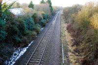Looking west to Hereford at the closed Ashperton station. There is still a station building to the left and is that the edge of the platform amongst the undergrowth?<br><br>[Ewan Crawford 31/01/2010]