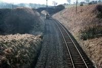 View south over Flex cutting in 1971, with track lifting in progress on the Waverley route approximately two miles south of Hawick station. [See image 22730]<br><br>[Bruce McCartney //1971]
