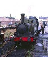 <I>Excuse me, but isn't this a record...  </I>Layerthorpe station, York, on the Derwent Valley Light Railway, in 1979. Worsdell ex-NER Clas E1 (LNER Class J72) no 69093 <I>Joem</I> takes on water via the platform hosepipe. Some 113 examples of this sturdy and reliable class were built in 9 batches over an elapsed period of 53 years between 1898 and 1951, a record production span for a British steam locomotive. <br><br>[Peter Todd ../../1979]