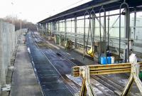 The present day fuelling facilities at Perth are located around the former platforms 8 and 9. This is a view of the 'half shed' and fuelling pumps installed a couple of years ago to handle the servicing of the Class 170s, including their associated CETs (Controlled Emission Tanks). Class 158's have all now been similarly adapted so the toilets can now be safely flushed in stations! The two stainless steel machines beyond the green wheeled bowser are two of the three CET pumps. Needless to say the latter are referred to in more colloquial terms locally.<br><br>[Gary Straiton 26/02/2010]