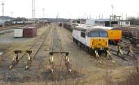 General view south over Warrington yard on 3 March 2010 with 56018 stabled alongside some yellow Network Rail coaches amongst various wagons. <br>
<br><br>[John McIntyre 03/03/2010]