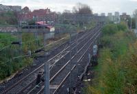 Looking east from Dalmuir station to the former Up Refuge Siding in 1989. This was taken out of use as part of the Yoker re-signalling scheme. In the middle distance the line crosses over the Glasgow, Yoker and Clydebank Railway (out of sight to the left) which also burrowed under the Forth and Clyde Canal.<br><br>[Ewan Crawford //1989]