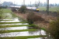 The up <I>'Flying Scotsman'</I> hurries past flooded fields on the approach to Tollerton, approximately 10 miles north of York, on 25 March 2010.<br><br>[John Furnevel 25/03/2010]