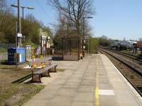 Shipton Station on the Cotswold Line looking along the up platform towards Oxford, with modern waiting shelter and platform bench incorporating the GWR legend in the cast legs. Work is currently in progress between the rear of the bench and the entrance gate. <br><br>[David Pesterfield 17/04/2010]