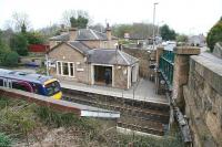 View north over the platforms and main station building at Polmont on 23 April 2010 as a 'non-stop' runs through westbound with an Edinburgh Waverley - Glasgow Queen Street service.<br><br>[John Furnevel 23/04/2010]