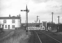 Glasgow Road level crossing in Bathgate in February 1970 [see image 29152] looking north west towards Bathgate Lower station. The sign on the building to the left on the other side of the crossing indicates use by the local Civil Defence Corps, stood down in the UK in 1968.<br><br>[Bill Jamieson /02/1970]