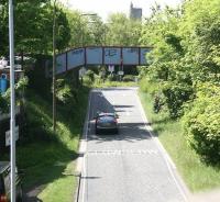 Photograph taken on June 2010 looking south west along the trackbed of the Caledonian a mile out of Princes Street, shortly after passing the site of Dalry Junction. The footbridge that spanned the tracks here still survives although nowadays it carries pedestrians between Dundee Terrace (left) and Dundee Street over what is now an exit from Edinburgh's Western Approach Road. Merchiston station lay straight ahead just beyond and to the left of St Michael's Parish Church on Slateford Road, the tower of which stands in the background.<br>
<br><br>[John Furnevel 03/06/2010]