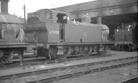 'Jinty' no 47490 standing on Sutton Oak shed (8G), St Helens, in 1962. Sutton Oak was officially closed in 1967 with the former 10 road straight shed being subsequently converted for use as a supermarket.<br><br>[K A Gray 15/04/1962]