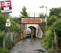 Entrance to Craigendoran station from Dennistoun Crescent on the north side of the line in June 2010. The tunnel passes below the West Highland tracks and opens out onto the station's remaining operational platform. The Clyde can be seen beyond. <br><br>[John Furnevel 08/06/2010]