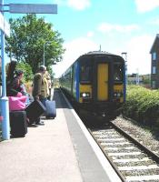The 1045 National Express East Anglia service from Norwich arrives at the BRB 1967 Sheringham terminus in bright sunshine on 15 June 2010. The previously severed level crossing behind the camera beyond which stands the original station, now operated by the North Norfolk Railway, was recently reconnected after 46 years. [See image 28075]<br><br>[Bruce McCartney 15/06/2010]