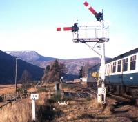 A Class 40-hauled train pulls into the loop at Dalnaspidal in November 1976, just months before semaphore signalling and the local box disappeared in the Blair Atholl-Dalwhinnie redoubling scheme. The dramatic backdrop is formed (from left to right) by The Sow of Atholl, A' Mharconaich and the Boar of Badenoch.<br><br>[Frank Spaven Collection (Courtesy David Spaven) /11/1976]