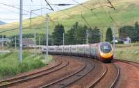 The 1740 hrs Glasgow Central to London Euston Pendolino service leans into the curve as it passes the Abington loops on 3 July 2010. <br>
<br><br>[John McIntyre 03/07/2010]