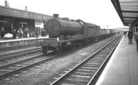 Class O4 2-8-0 no 63802, displaying a local 36A shedplate, takes a lengthy freight south on the centre road through Doncaster station on 28 July 1962.<br><br>[K A Gray 28/07/1962]