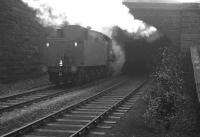 The back end of hard-working Austerity 2-8-0 no 90434 is about to disappear into the smoke-filled tunnel at the west end of Beamish station in the winter of 1964. In front of the locomotive is iron ore bound for the blast furnaces at Consett, with BR Standard class 9F 2-10-0 no 92097 working just as hard at the other end. Conditions on the footplate inside the tunnel must have been grim.   <br><br>[K A Gray 15/02/1964]
