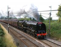 Ex-LMS <I>Coronation</I> Pacific no 6233 <i>Duchess of Sutherland</i> heads north on the WCML on 24 July 2010 with the <I>Cumbrian Mountain Express</I> from Liverpool to Carlisle. The train has just restarted from Barton Down Loop, having been held to allow passage of a northbound Pendolino.<br><br>[John McIntyre 24/07/2010]