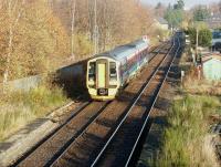 Morning train from Kyle to Inverness arriving at Muir of Ord in November 2003.<br><br>[John Furnevel 23/11/2003]
