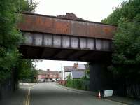 This nicely decorated bridge on the line from Three Spires Junction to the WCML used to carry trains of Rootes car bodies from Linwood, Renfrewshire, to Gosford Green, Coventry. When Linwood closed, rail traffic stopped. Now the Rootes/Chrysler/Talbot/Peugeot plant has been demolished, but the old bridge remains...<br><br>[Ken Strachan 13/06/2010]