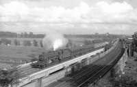 A Black 5 takes a train north over the River Eden at Etterby, thought to be in the summer of 1967. In the right background a diesel shunter is approaching with a short freight on the goods lines and is just about to pass the sidings of Willowholme power station. <br>
<br><br>[Robin Barbour Collection (Courtesy Bruce McCartney) //1967]