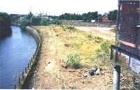 Scene looking west from Benalder Street bridge over the site of Partick Central alongside the River Kelvin in July 2001. For some reason most of the trees and shrubbery had been cleared from the site around this period, thus allowing the old station platforms to be seen for the first time in many years. The station building stands on the right [see image 24316].<br><br>[Colin Miller /07/2001]