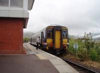 First train of the day, from Mallaig to Glasgow, on a misty overcast morning, calls at Banavie and is seen alongside the signalling centre. The guard rejoins 156456 before the train moves off for the next stop (and reversal) at Fort William. <br><br>[Mark Bartlett 19/05/2010]