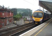 The through westbound platform at Manchester Piccadilly sees TPE 185144 calling on a Liverpool service. Across the road the closed Manchester Mayfield terminus building can be seen. [See image 30083]<br><br>[Mark Bartlett 09/07/2010]