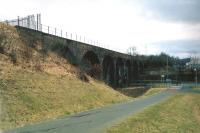 View west at Cargenbrdge Viaduct towards Castle Douglas on 16 March 2010. The viaduct marks the end of the 'Maxwelltown Railway Path', a tarmac surfaced cycling and walking route from Dumfries which now runs along the old trackbed. [See image 25379] Part of the former Cargenbridge ICI Works can be seen on the right. [The viaduct itself is currently fenced off having been officially declared an 'unsafe structure'.]<br><br>[Ken Strachan 16/03/2010]