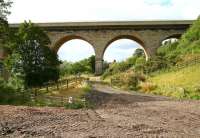 The north end of Newton Cap Viaduct on 30 September 2010 looking west from a track alongside the appropriately named 'Eleven Arches Golf Range'. The River Wear runs past on the left with the town of Bishop Auckland standing beyond. The 153 year old structure, designed by Richard Cail on behalf of the North Eastern Railway and opened in 1857, now carries road traffic on the A689. [See image 30910]    <br><br>[John Furnevel 30/09/2010]