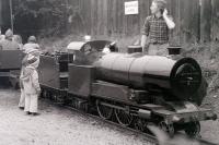 Two mini-enthusiasts admire the locomotive on the miniature railway (15' gauge?) that used to run along the western perimeter of the site at Steamtown, Carnforth, passing through the loco shed on the way.<br>
<br><br>[Colin Miller //1979]