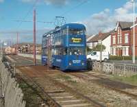 Rebuilt double-deck car 724 heads south from Cleveleys town centre on a service for Blackpool Pleasure Beach. The tracks here are on a reserved section in the middle of a dual carriageway but with several crossing points. [See image 22562] for the same location some eighteen months earlier when the line was closed for refurbishment.<br><br>[Mark Bartlett 16/10/2010]