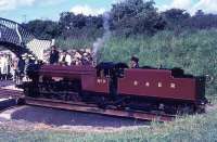 Brand new for that season 2-8-2 <I>River Mite</I> is seen on the turntable at Ravenglass in summer 1966 being made ready for another run up to Dalegarth. Forty four years later she is still in regular use on the line and must have repaid the investment in her many times over. <br><br>[David Hindle /07/1966]