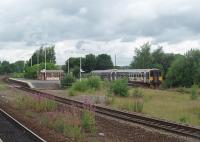 Leyland unit 155344 on a Leeds service pulls away from a stop at Mirfield's island platform, as seen from the third platform that serves westbound trains. The centre road allows fast trains heading west to overtake slower ones as the through line does at Dewsbury, just east of here, for Leeds bound trains. [See image 23146]<br><br>[Mark Bartlett 20/07/2010]