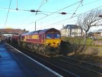 DBS locomotive 66155 powers through Ardrossan South Beach station with heavy haul train 6G07 fully loaded Hunterston HL sidings-Longannet power station.<br><br>[Ken Browne 19/01/2011]