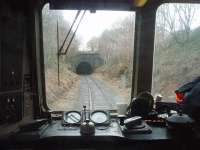 DMU driver's eye view of the south portal of Nuttall Tunnel on the East Lancashire Railway. The train is in the short cutting between Nuttall and the longer Brooksbottom Tunnel from where it will emerge on to Summerseat viaduct.  <br><br>[Mark Bartlett 01/01/2011]