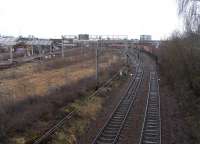 The disused sidings of Smithy Lye are to the left of the City Union <br>
line in this view east from Shields Road on 5 February. The Glasgow and Paisley line is at their other side. The overhead wire beneath the <br>
camera serves the line connecting the CU and the G&P, and the points are currently set for it.<br><br>[David Panton 05/02/2011]