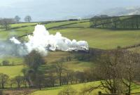 After a break at Buxton, Black 5 no 44871 and Jubilee no 5690 <br>
<I>Leander</I> are seen with the return leg of the <I>Buxton Spa Express</I> on 26 February heading east near the 2 mile 182 yard Cowburn Tunnel. The tour had followed a stone train down from Great Rocks Junction and as a result was over 30 minutes late getting away from Chinley East Junction.<br>
<br><br>[John McIntyre 26/02/2011]