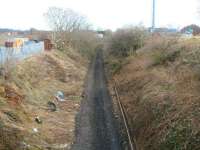 Scene on the Edinburgh, Loanhead and Roslin route approximately 2 miles south west of Millerhill Yard on 2 March 2011. The trackbed here is now clear with recently lifted rails lying alongside. Behind the camera two teams are currently engaged in the recovery of concrete sleepers. View is east from a farm overbridge looking towards the site of  the former Gilmerton station. [See image 36048]<br><br>[John Furnevel 02/03/2011]
