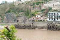View across the Avon on 11 March, a short distance south of the former Hotsprings railway terminus, showing abandoned landing stages and the lower entrance to the Clifton Rocks Railway, built into the face of the Avon Gorge [see image 17977]. The former funicular railway, closed in 1934, is currently the subject of  considerable preservation activity. <br><br>[Peter Todd 11/03/2011]