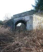 Looking south west towards the site of Roslin station (now a housing development) along the overgrown EL&RR trackbed on 28 February 2011. The rail route and public walkway from Loanhead have parted company by this time with the latter now crossing the heavily overgrown formation via the skew-arch overbridge and continuing towards the centre of the village just over quarter of a mile away to the left.<br>
<br><br>[John Furnevel 28/02/2011]