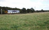 A westbound Sprinter passes the site of Thornton Weighs and shed - now a field with no hint of former use. View looks east. September 2004. [See image 33514]<br><br>[Ewan Crawford 15/09/2004]