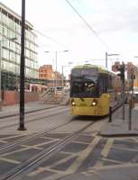 New generation tram 3006 leaves the Shudehill Interchange heading for the next stop at nearby Manchester Victoria on its way to Bury. Shudehill tram stop opened in 2003 and the full bus interchange some three years later. The 3000 series trams are being introduced to cover the services on the new Metrolink lines to Rochdale, Ashton and Didsbury but are being used alongside the existing 1000 and 2000 series vehicles on Bury and Altrincham service in the interim. <br><br>[Mark Bartlett 19/03/2011]